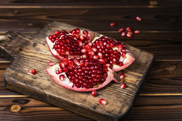 red ripe juicy pomegranate on wooden