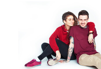 Fototapeta premium Young couple together. guy with tattoo, girlfriend wearing dreadlocks having fun on white background
