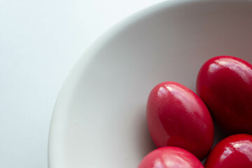 Simple red easter eggs in ceramic bowl
