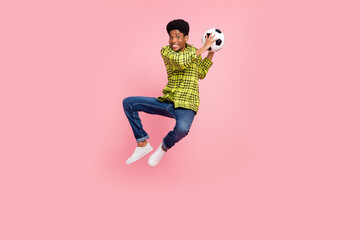 Fototapeta na wymiar Full body photo of millennial funky brunette guy jump with ball wear shirt jeans sneakers isolated on pink background