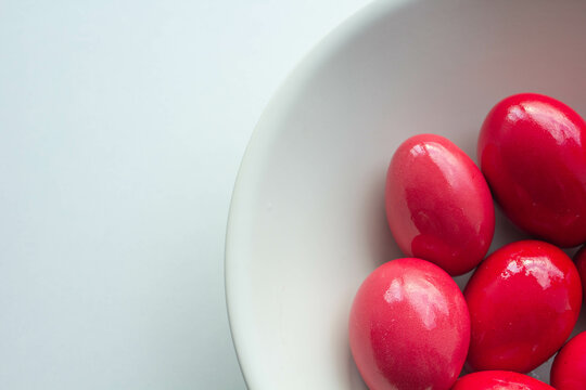 Red easter eggs in white ceramic bowl