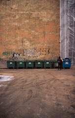 Many garbage bins for sorting waste standing in the yard