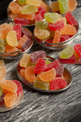 Fototapeta na wymiar Dessert marmalade in the form of lemon and orange slices. The sweetness of jelly candy.