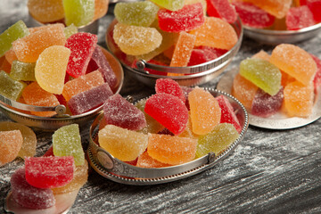 Dessert marmalade in the form of lemon and orange slices. The sweetness of jelly candy.