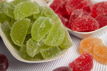 Dessert marmalade in the form of lemon and orange slices. The sweetness of jelly candy.