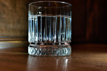 Faceted glass on wooden table