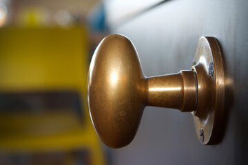 Brass door knob on a black metal door
