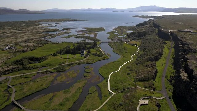 Cinematic aerial footage of Thingvellir national park, Iceland's parliament, the Thingvellir Church and the ruins of old stone shelters, hikes and lake in the golden circule