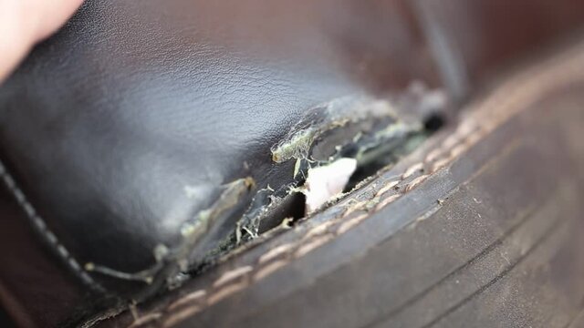 Torn sole on trendy winter shoes. Poor quality winter boots, macro