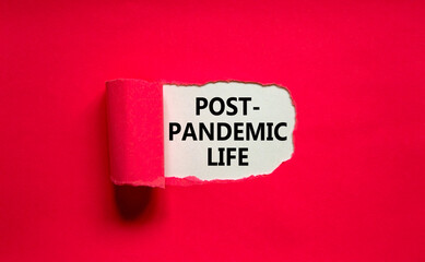 Post-pandemic life symbol. Words Post-pandemic life appearing behind torn pink paper. Beautiful pink background, copy space. Medical and COVID-19 pandemic post-pandemic life concept.