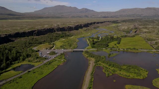 Cinematic aerial footage of Thingvellir national park, Iceland's parliament, the Thingvellir Church and the ruins of old stone shelters, hikes and lake in the golden circule