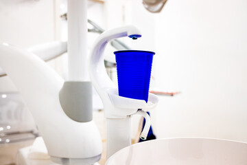 Plastic cup for mouthwash on a dentist chair.
