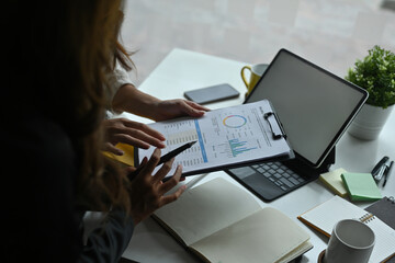 Close up image of a businesswoman explaining a business plan to colleagues at a corporate meeting room.