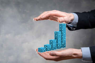 Business man holding 3D graphs low polygonal and stock market statistics gain profits. Concept of growth planning,business strategy.economic growing concept.Business strategy. Digital marketing.