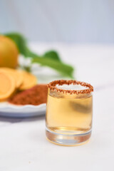 Mexican mezcal shot with chili pepper and orange.