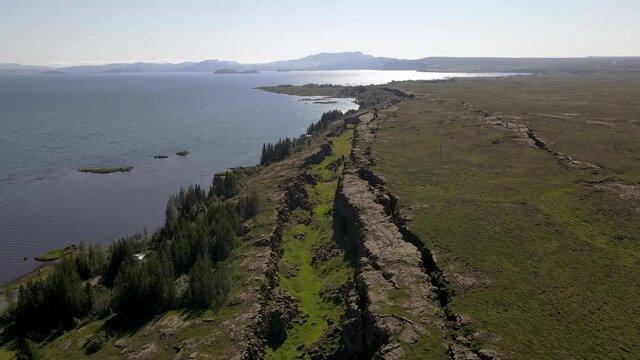 Cinematic aerial footage of Thingvellir national park, Iceland's parliament, the Thingvellir Church and the ruins of old stone shelters, hikes and lake in the golden circule