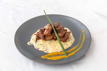 lamb meat with sauce on white background