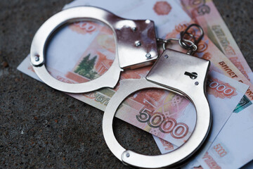 handcuffs are on five-thousand-dollar Russian banknotes