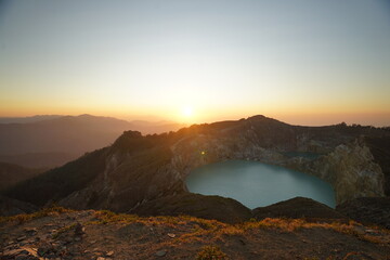 Enjoying sunrise on the top of Kelimutu National Park mountain