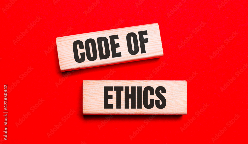 Poster on a bright red background, there are two light wooden blocks with the text code of ethics