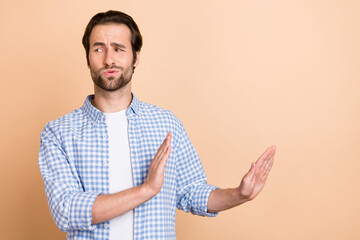 Photo of sad young guy dislike wear blue shirt isolated on beige color background