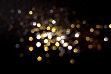 Golden and silver blurred bokeh lights on black background. Glitter sparkle stars for celebrate. Overlay for your design