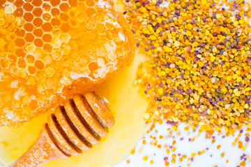 Honey with dipper, honeycomb and bee pollen on white background. 