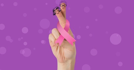 Obraz na płótnie Canvas Composite image of breast cancer ribbon with hand gesture against purple background, copy space