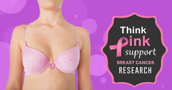 Composite image of woman in pink bra with breast cancer awareness slogan against purple background