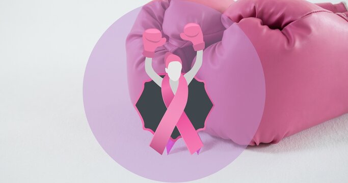 Composite image of breast cancer awareness ribbon with boxing gloves on white table with copy space