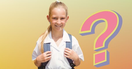 Portrait of smiling schoolgirl with backpack by question mark over beige background
