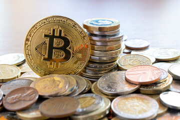 bitcon coin in the middle of multiple coins. cryptocurrency concept