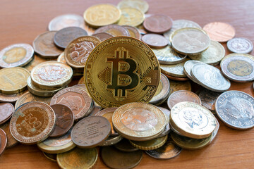 bitcon coin in the middle of multiple coins. cryptocurrency concept