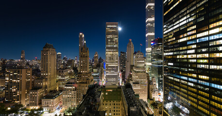 Travel to New York. View from above to Manhattan in the middle of the night with full moon in the...