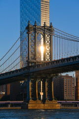 Travel to New York. The skyline of Manhattan photographed during a summer sunrise, view to Manhattan Bridge. Landmarks of United States of America. Skyscraper office buildings.