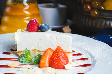 Piece of classic cheesecake with strawberries on a plate