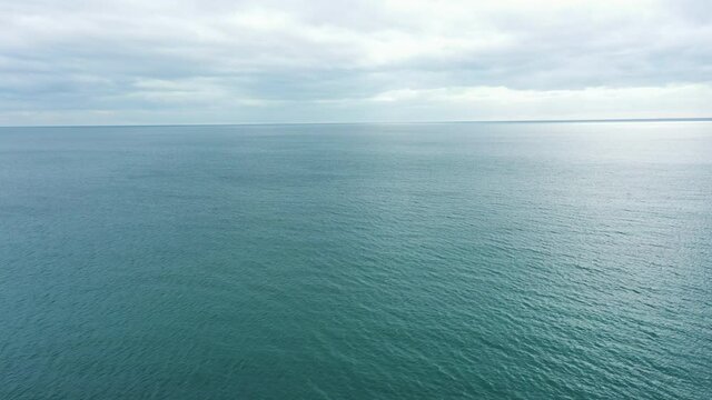 The calm blue open sea on an overcast day, UK