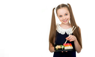 Cute smiling little girl with with sushi on white background. Student child girl eating sushi and rolls - commercial concept