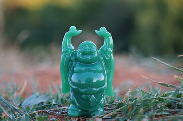 A Buddha figure on a colored natural background. Religious and spiritual symbol.