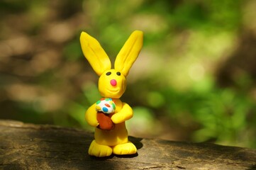 Easter bunny with a cake in his hands. The symbol of Easter.