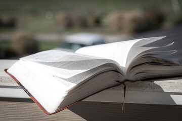 Open Bible with bookmark outside with pages flipping