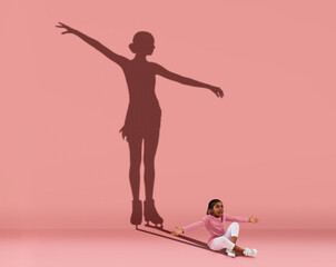 Little girl dreaming about big and famous sport future. Conceptual image with kid and shadow of...
