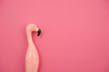pink plastic Flamingo bird on pink background - mock up for design and product display