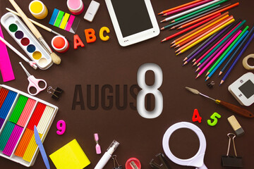 August 8th. Day 8 of month, Calendar date. School notebook and various stationery with calendar day. School and office supplies frame. Summer month, day of the year concept.