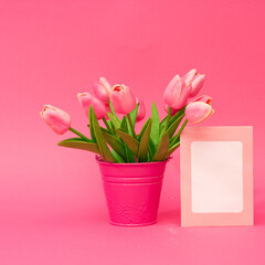 pink tulips in pink basket  and paper card note. Romantic art concept