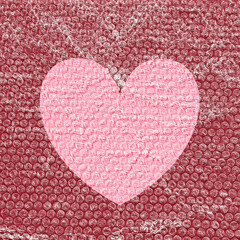 Bubble wrap on top of a heart symbol with copy space