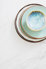 assorted ceramic plates on white marble table