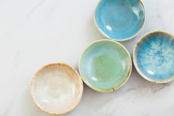 assorted ceramic plates on white marble table