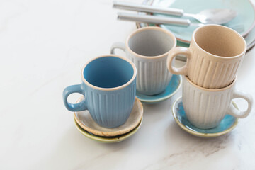 ceramic cups and plates on white marble table
