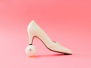 White shoes and white new year ball  on pink background